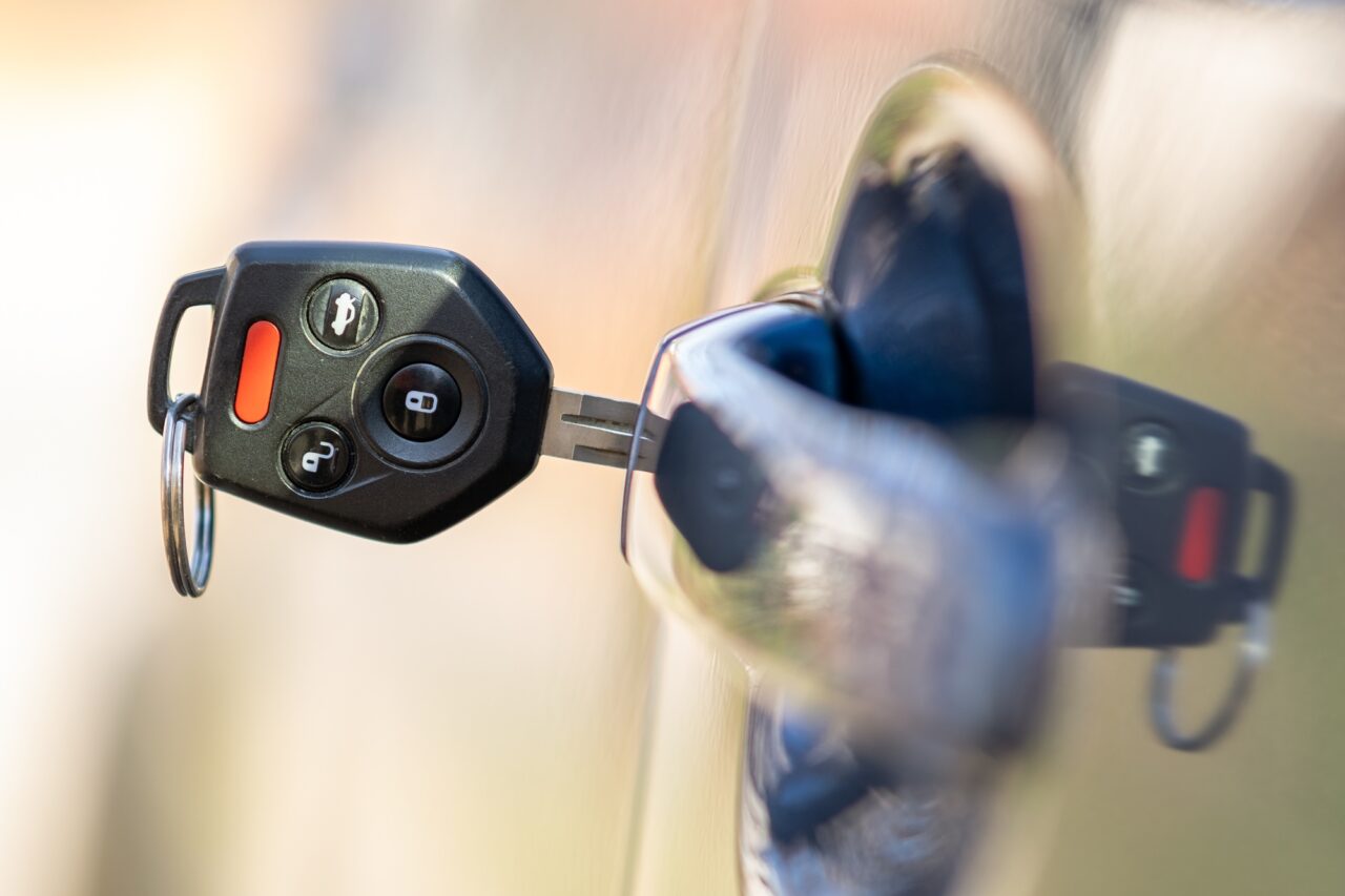 close up of car door with key sticking out of the lock concept of process opening or closing 1