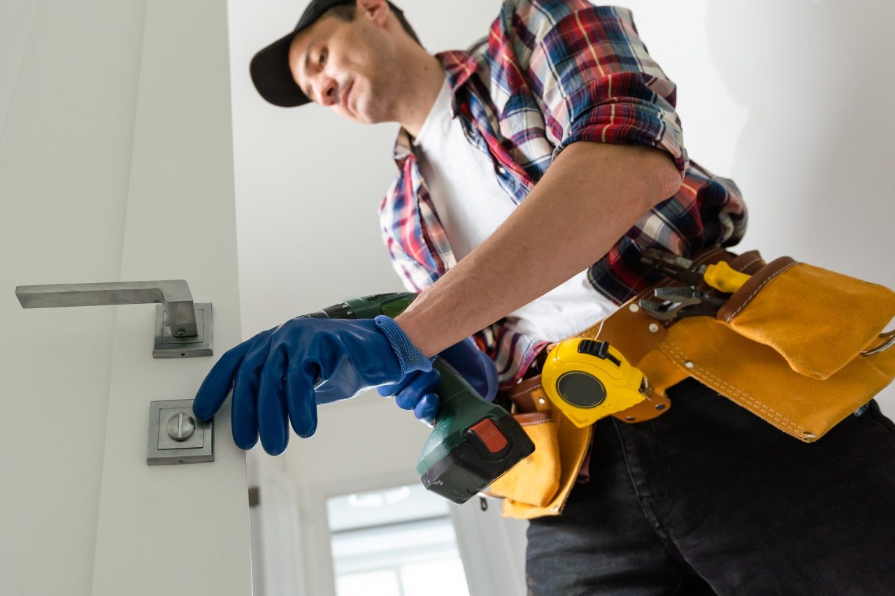 man removing lock from door